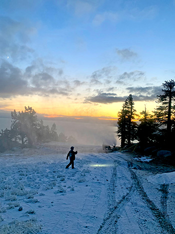snowmaker with sunrise over lake tahoe at diamond peak ski resort
